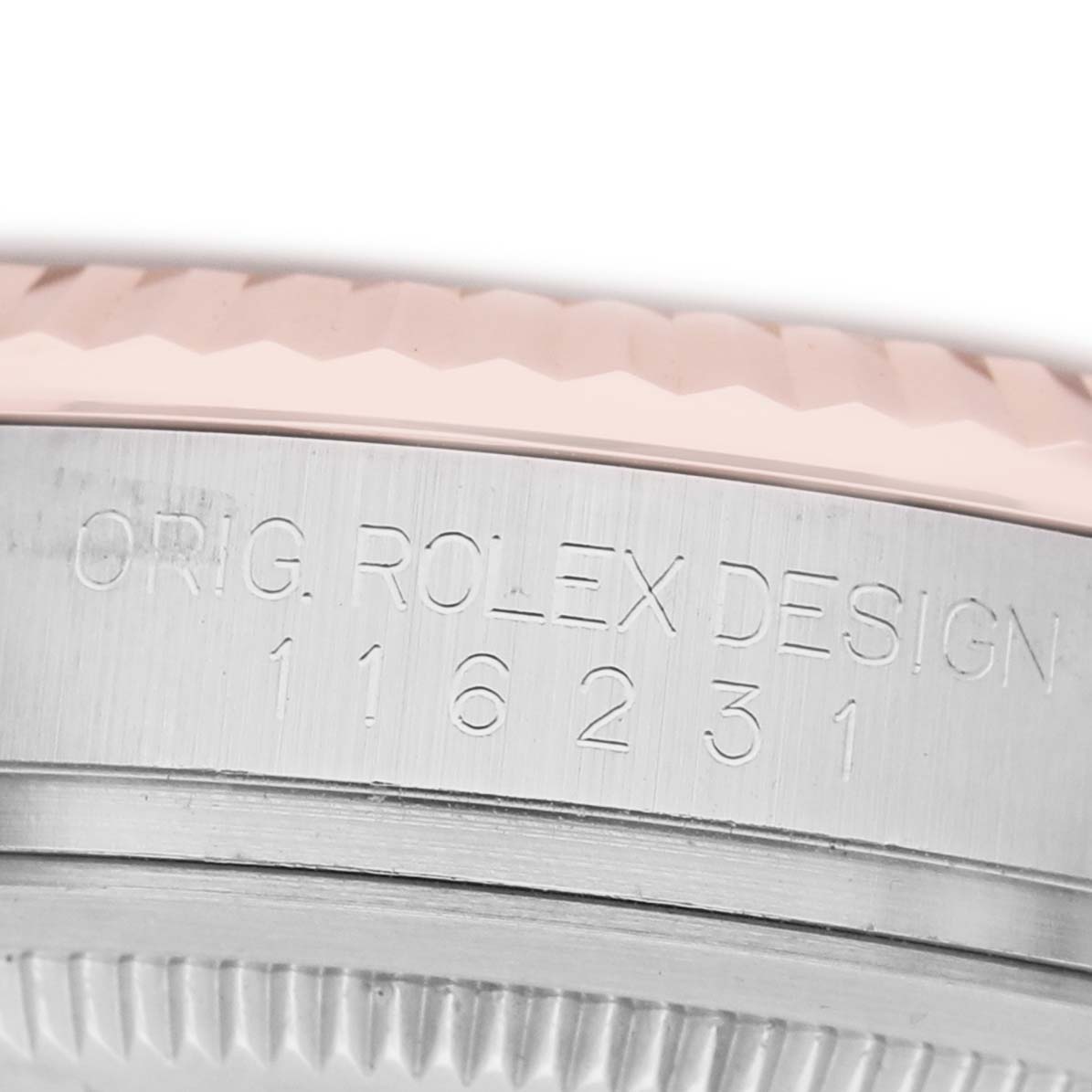 The image shows a close-up of the side engraving on the case of a Rolex Datejust 116231 Men's Steel and Gold (two tone) Black Dial watch, displaying the model number.
