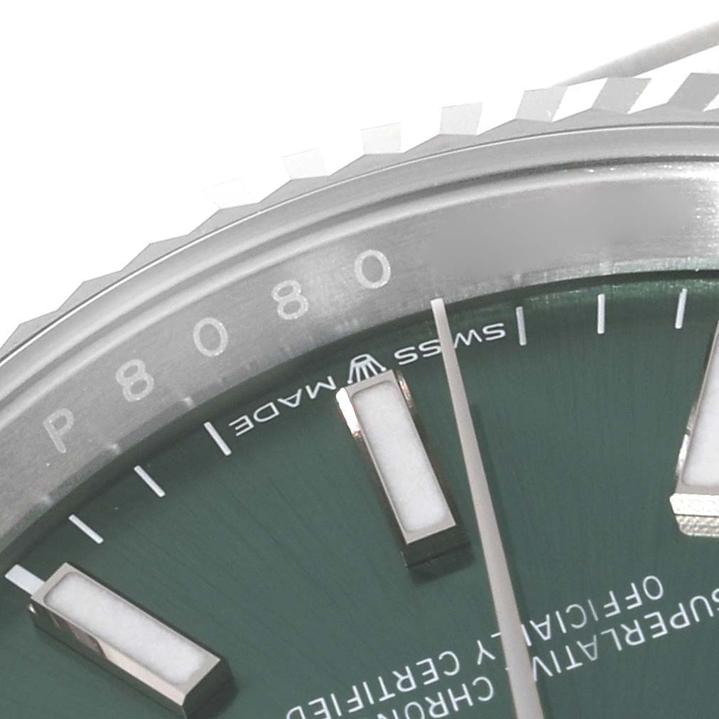 The Rolex Datejust 126234 Men's Stainless Steel Green Dial 126234 Men's Stainless Steel Green Dial watch is shown at an angle, highlighting part of the dial, bezel, and markers.