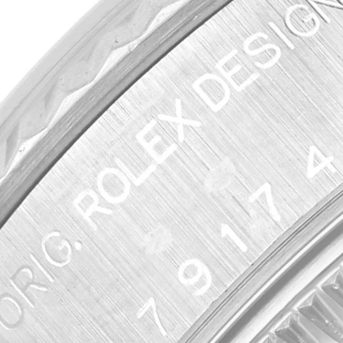 The image shows an angled close-up of the brushed metal case and engraved serial number of a Rolex Datejust 79174 Women
s Stainless Steel Mother of Pearl Dial 79174 Women
s Stainless Steel Mother of Pearl Dial watch.