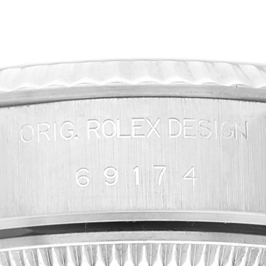 The image shows a close-up of the side of a Rolex Datejust 69174 Women's Stainless Steel Pink Dial 69174 Women's Stainless Steel Pink Dial watch case, displaying the engraved model number "69174" and "ORIG. ROLEX DESIGN".