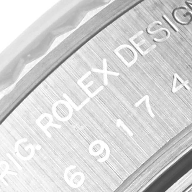 This close-up angle shows the engraved branding on the bezel of a Rolex Datejust 69174 Women's Stainless Steel Pink Dial 69174 Women's Stainless Steel Pink Dial watch.