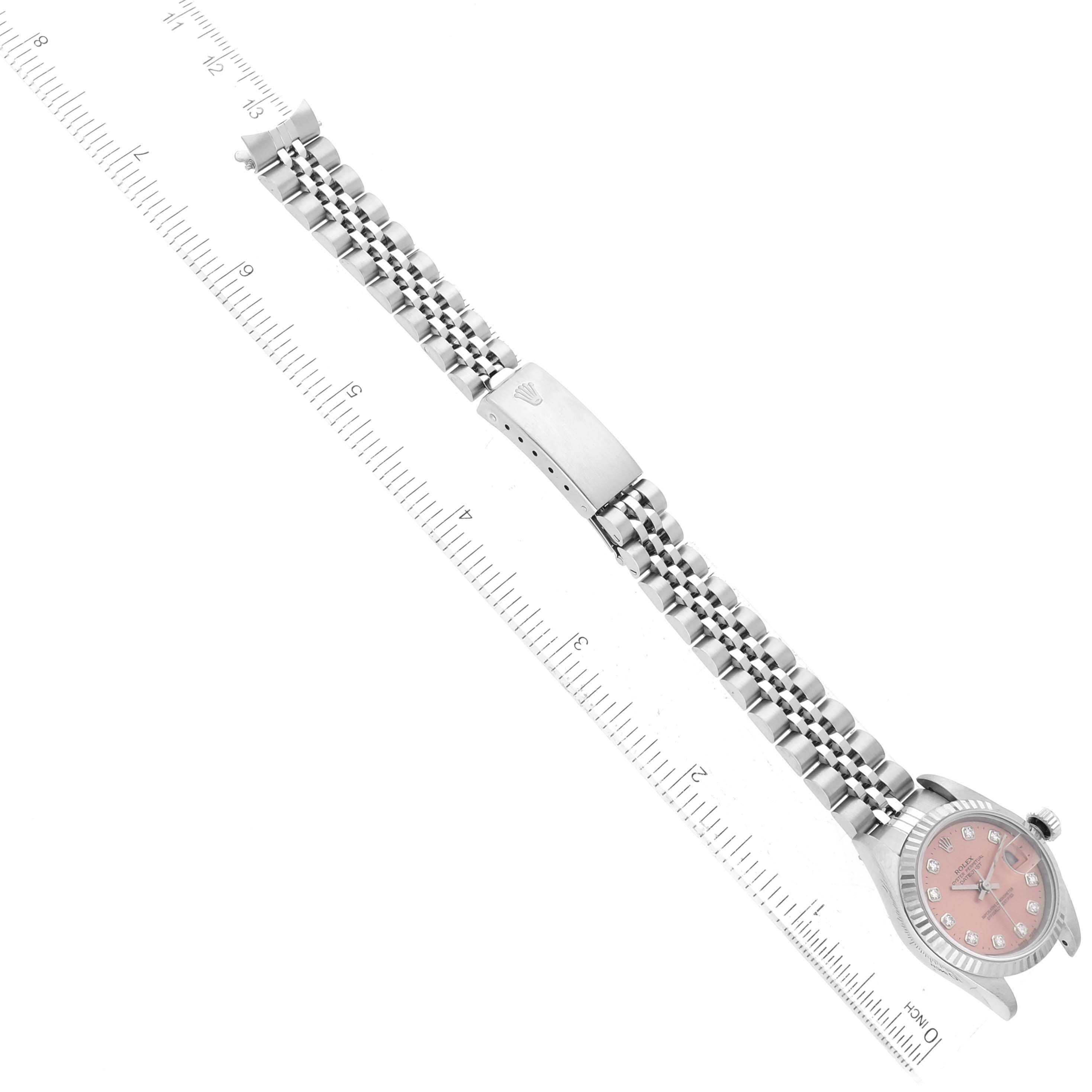 The image shows a Rolex Datejust 69174 Women's Stainless Steel Pink Dial 69174 Women's Stainless Steel Pink Dial watch lying flat, with a ruler measuring the length of the bracelet.
