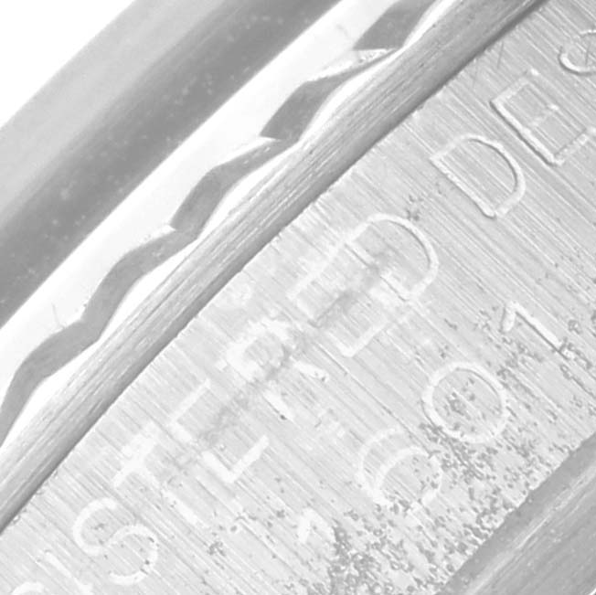The image shows a close-up of the bezel and engraved casing of the Rolex Vintage Collection 1601 Men's Stainless Steel Silver Dial 1601 Men's Stainless Steel Silver Dial watch.
