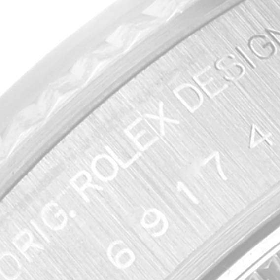 The image shows a close-up of the side engraving on a Rolex Datejust 69174 Women's Stainless Steel Silver Dial 69174 Women's Stainless Steel Silver Dial watch, highlighting the "Rolex Design" text.