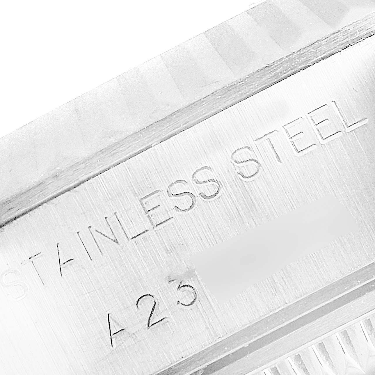 This close-up image shows the engravings on the stainless steel case of a Rolex Datejust 79174 Women's Stainless Steel Silver Dial 79174 Women's Stainless Steel Silver Dial watch.