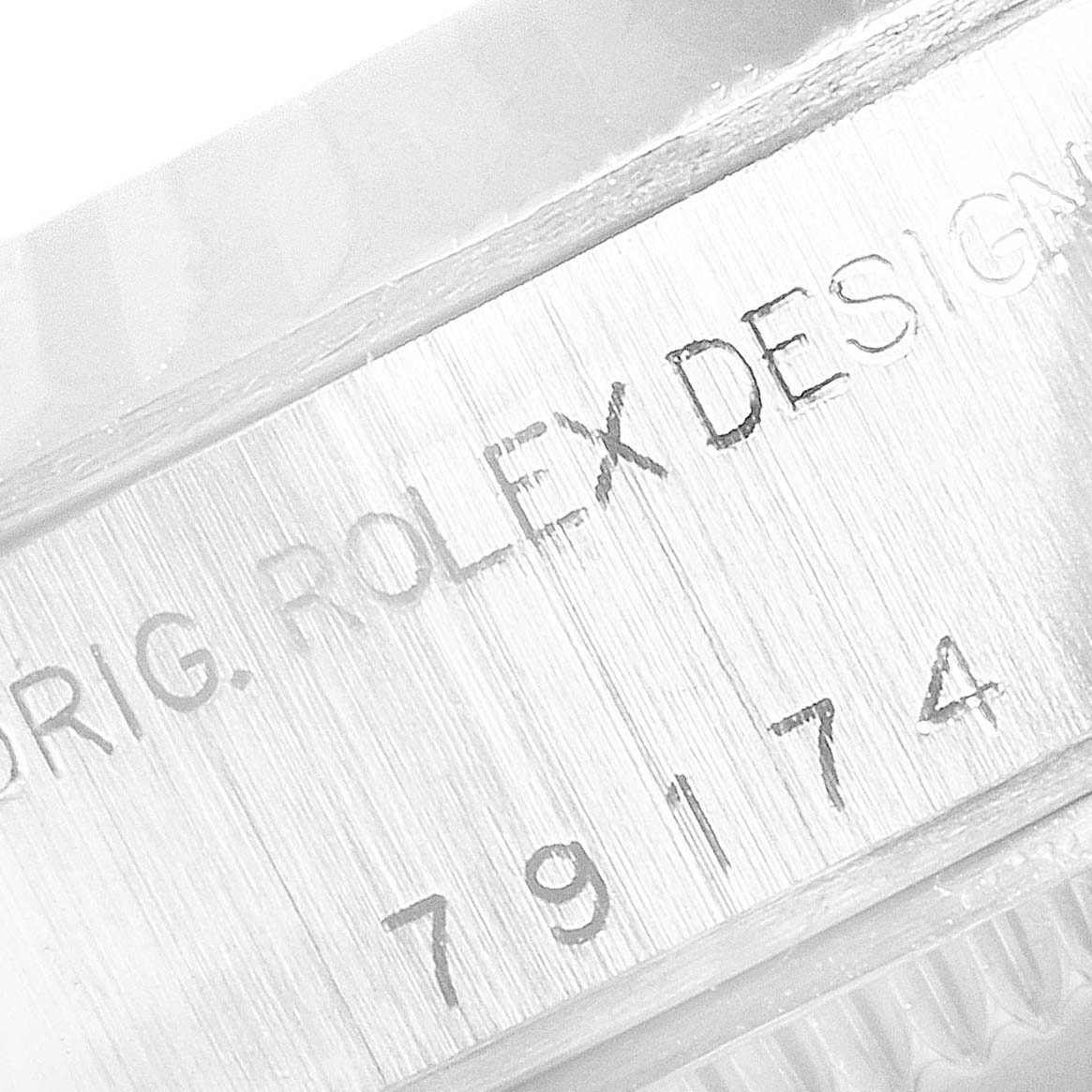 The image shows an angled view of the engraved model number and branding on the side of a Rolex Datejust 79174 Women's Stainless Steel Silver Dial 79174 Women's Stainless Steel Silver Dial watch case.