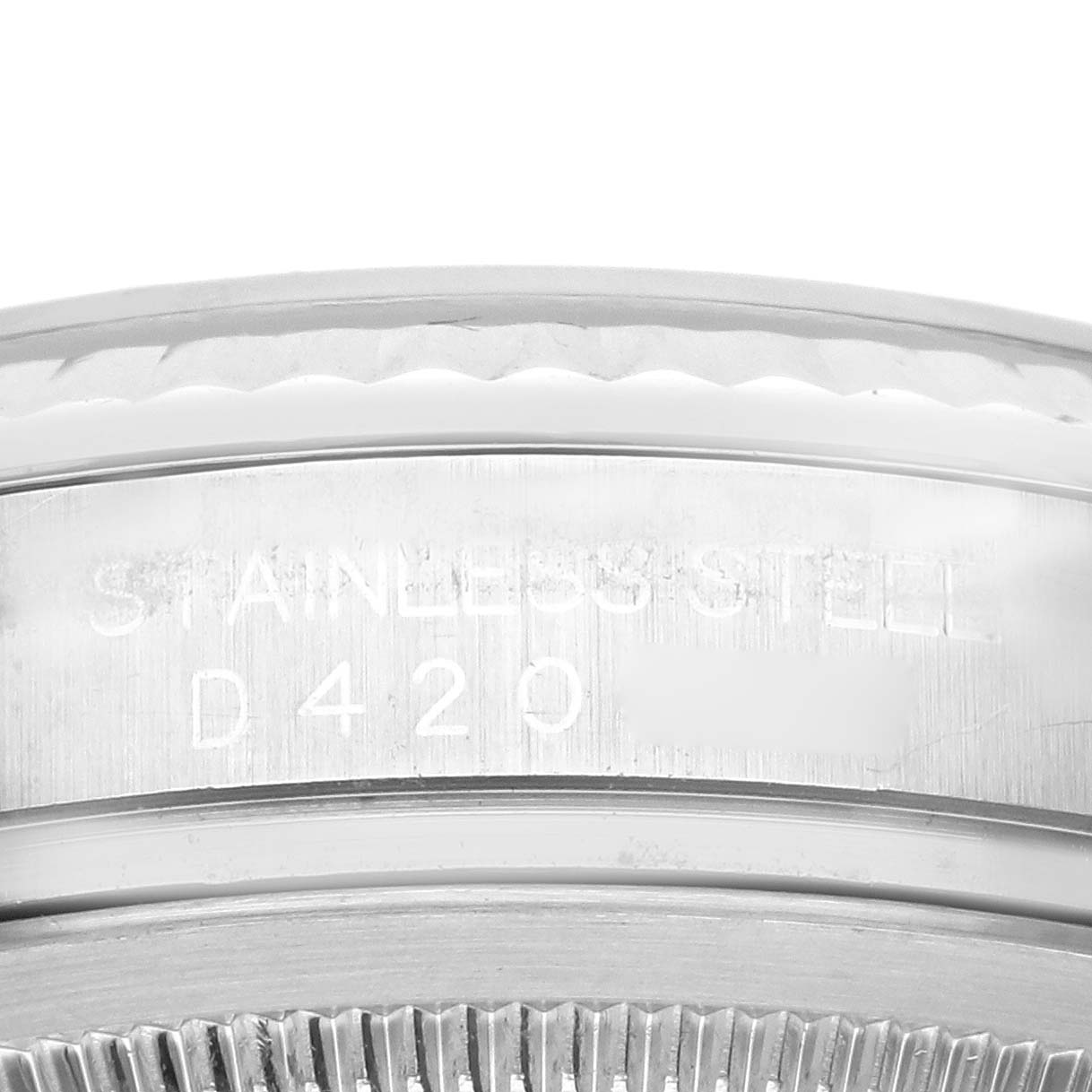 This image shows a close-up of the side of a Rolex Datejust 116234 Men
s Stainless Steel Silver Dial 116234 Men
s Stainless Steel Silver Dial watch, emphasizing its stainless steel case and engraved details.