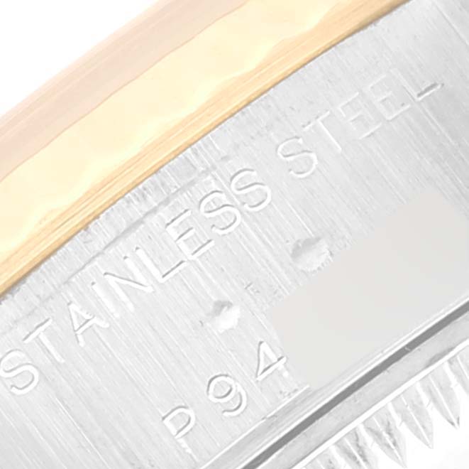 This image shows a close-up of the stainless steel part of a Rolex Datejust 79173 Women's Steel and Gold (two tone) Blue Dial 79173 Women's Steel and Gold (two tone) Blue Dial watch with engravings visible.