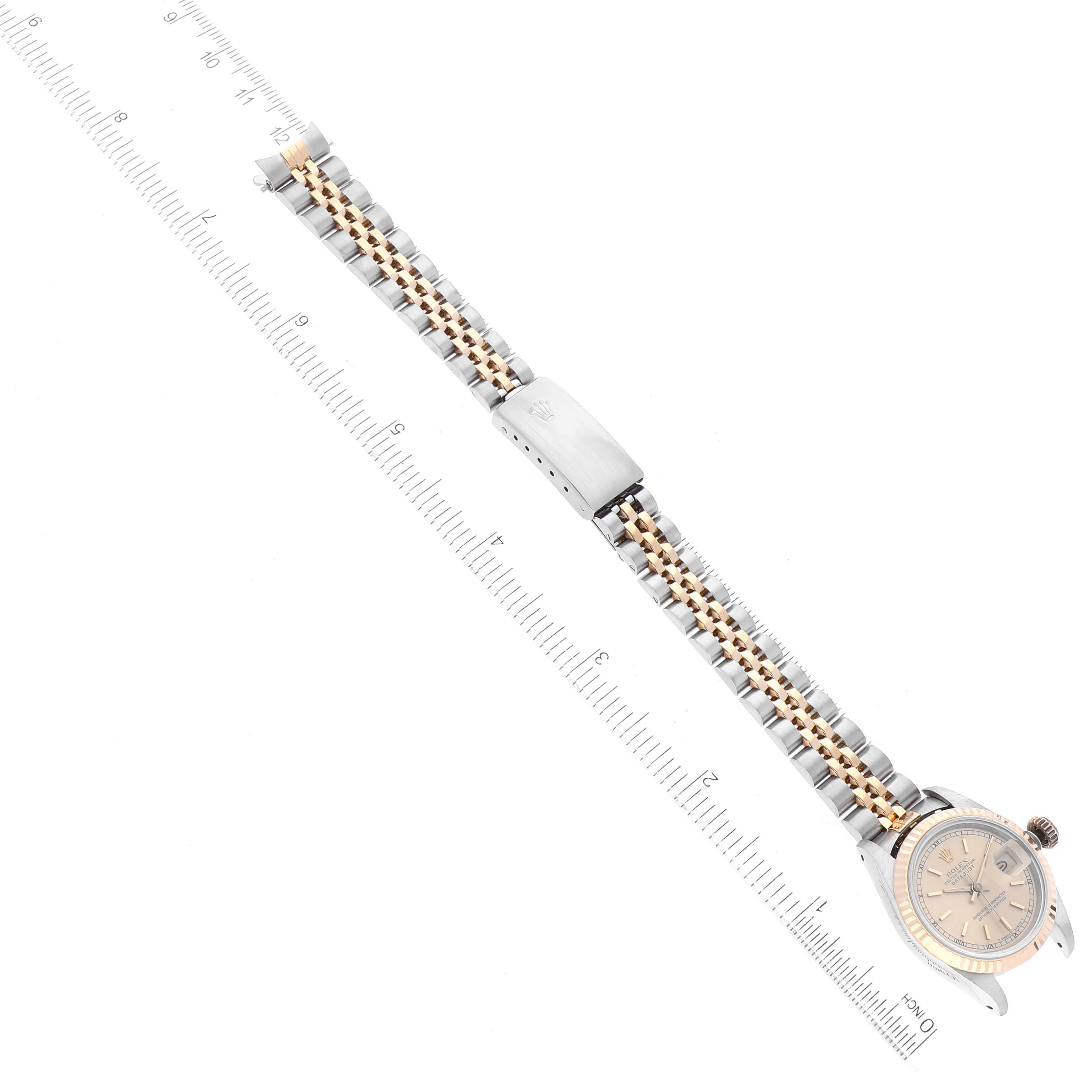 The image shows a Rolex Datejust 69173 Women's Steel and Gold (two tone) Champagne Dial 69173 Women's Steel and Gold (two tone) Champagne Dial watch with a two-tone band and ruler, captured from a top-down angle.
