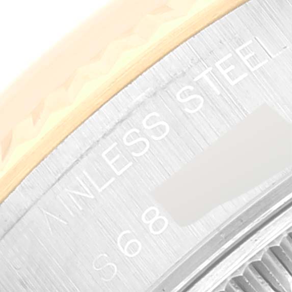 This close-up image shows the edge of the case, bezel, and part of the back with "Stainless Steel" on a Rolex Datejust 69173 Women's Steel and Gold (two tone) Champagne Dial 69173 Women's Steel and Gold (two tone) Champagne Dial.