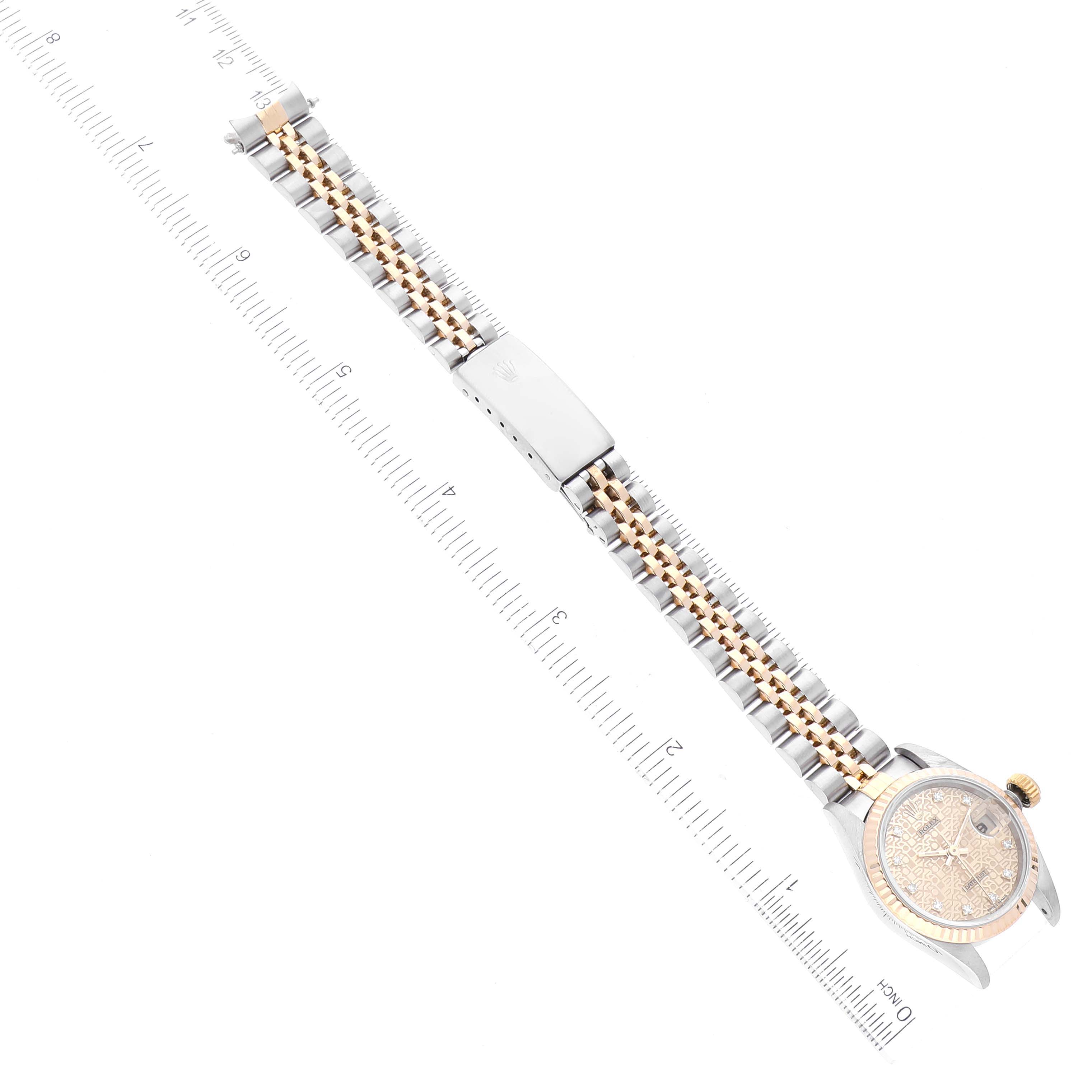 The image shows a top-down view of a Rolex Datejust 69173 Women's Steel and Gold (two tone) Champagne Dial 69173 Women's Steel and Gold (two tone) Champagne Dial watch, with its face, bracelet, and clasp visible alongside a ruler.