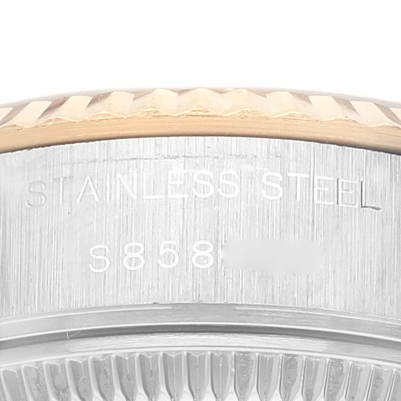 The image shows a close-up of the serial number and "STAINLESS STEEL" engraving on the side of a Rolex Datejust 69173 Women's Steel and Gold (two tone) Champagne Dial 69173 Women's Steel and Gold (two tone) Champagne Dial watch.