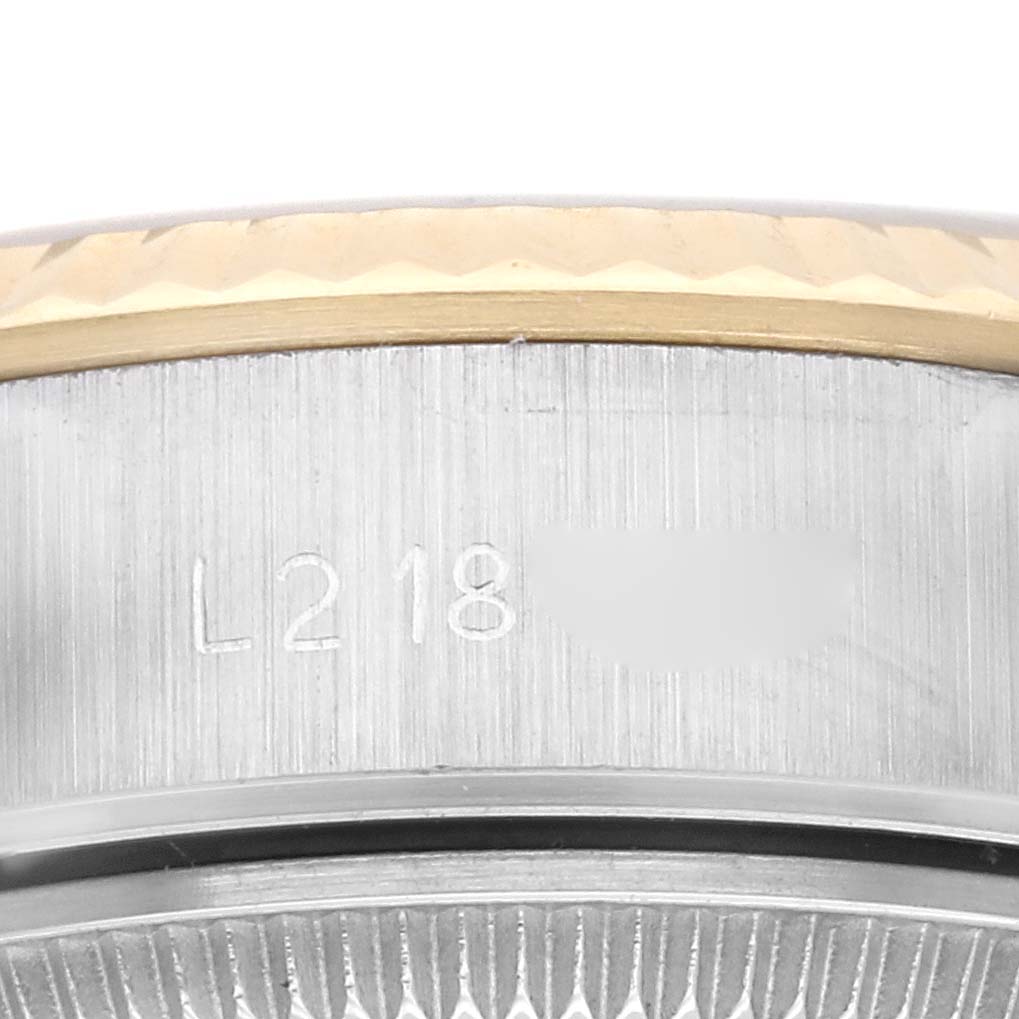 The image shows a close-up of the side of a Rolex Datejust 69173 Women's Steel and Gold (two tone) Champagne Dial 69173 Women's Steel and Gold (two tone) Champagne Dial, focusing on the serial number and part of the bezel.