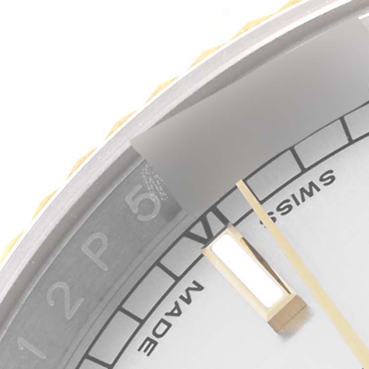 This close-up image of a Rolex Datejust 116233 Men
s Steel and Gold (two tone) Silver Dial 116233 Men
s Steel and Gold (two tone) Silver Dial watch shows the edge of the face with the Swiss Made marking and part of the hour markers.