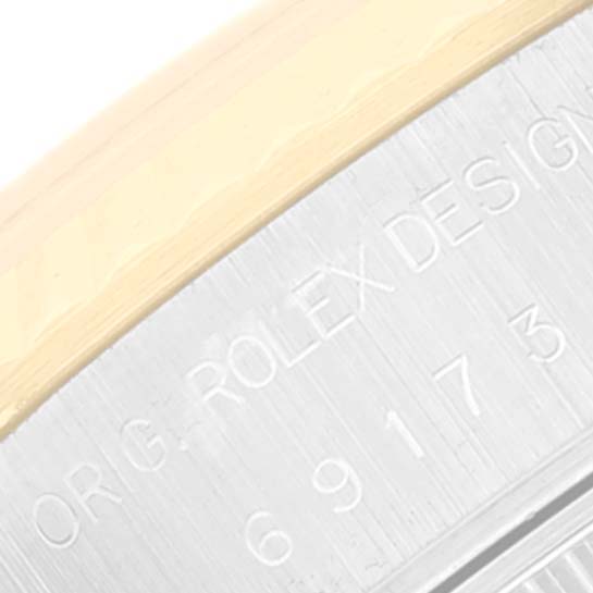 The image shows a close-up of the engraved bezel edge of a Rolex Datejust 69173 Women's Steel and Gold (two tone) Champagne Dial 69173 Women's Steel and Gold (two tone) Champagne Dial watch, highlighting the "ORIG. ROLEX DESIGN" text.