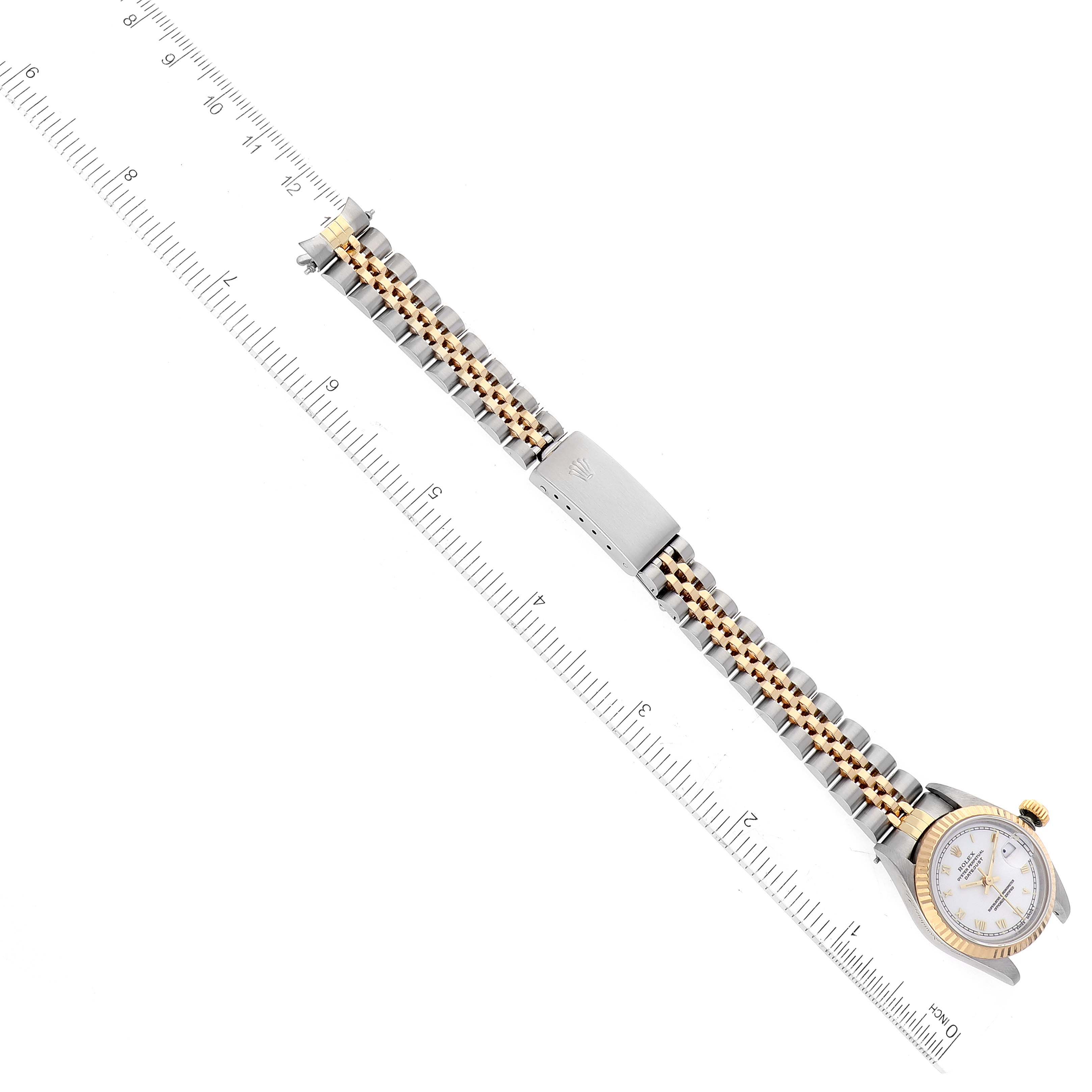 The image shows a Rolex Datejust 69173 Women's Steel and Gold (two tone) White Dial 69173 Women's Steel and Gold (two tone) White Dial watch laid flat with the face and bracelet visible, alongside a measuring ruler.