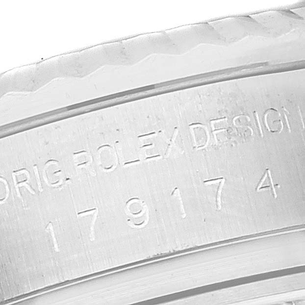This image shows a close-up of the engraved bezel and serial number on a Rolex Datejust 179174 Women's Stainless Steel Black Dial 179174 Women's Stainless Steel Black Dial watch.