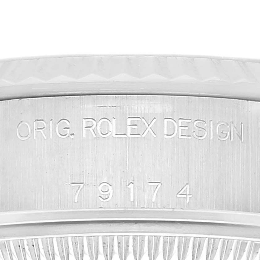 This image shows a close-up of the engraved case side of a Rolex Datejust 79174 Women's Stainless Steel Black Dial 79174 Women's Stainless Steel Black Dial watch with model number 79174.