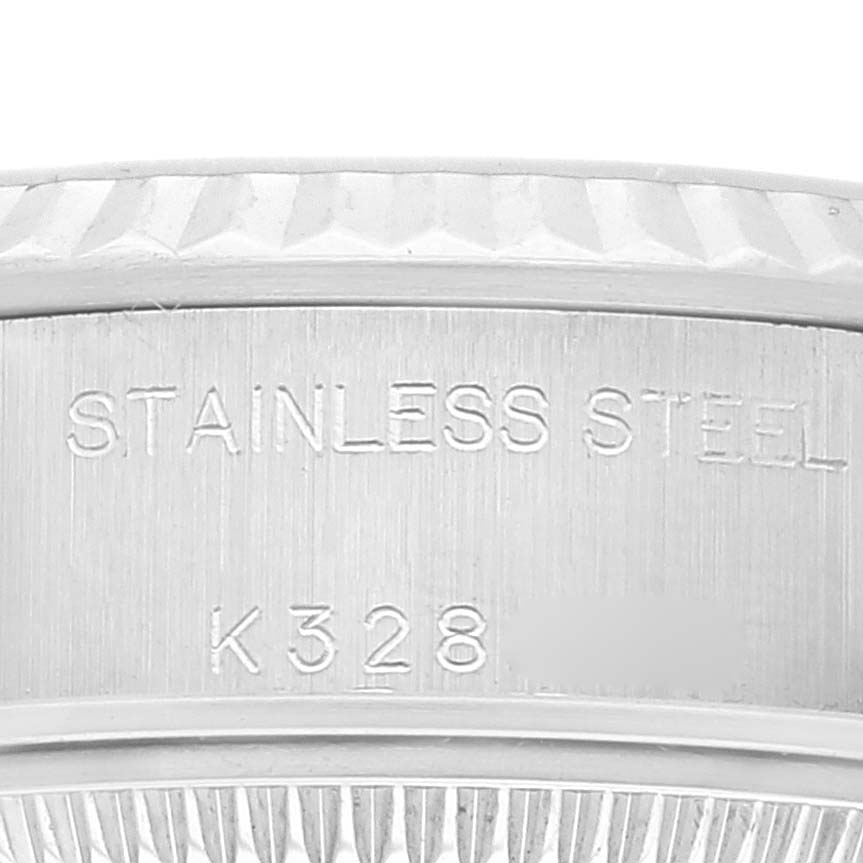 This close-up image shows the stainless steel engraving and part of the bezel of a Rolex Datejust 79174 Women's Stainless Steel Black Dial 79174 Women's Stainless Steel Black Dial watch.