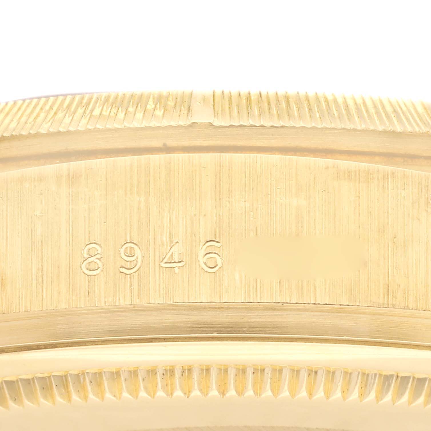 This image shows a close-up of the side and bezel of a Rolex President 18248 Men
s Yellow Gold Champagne Dial 18248 Men
s Yellow Gold Champagne Dial model watch, featuring engraved numbers.