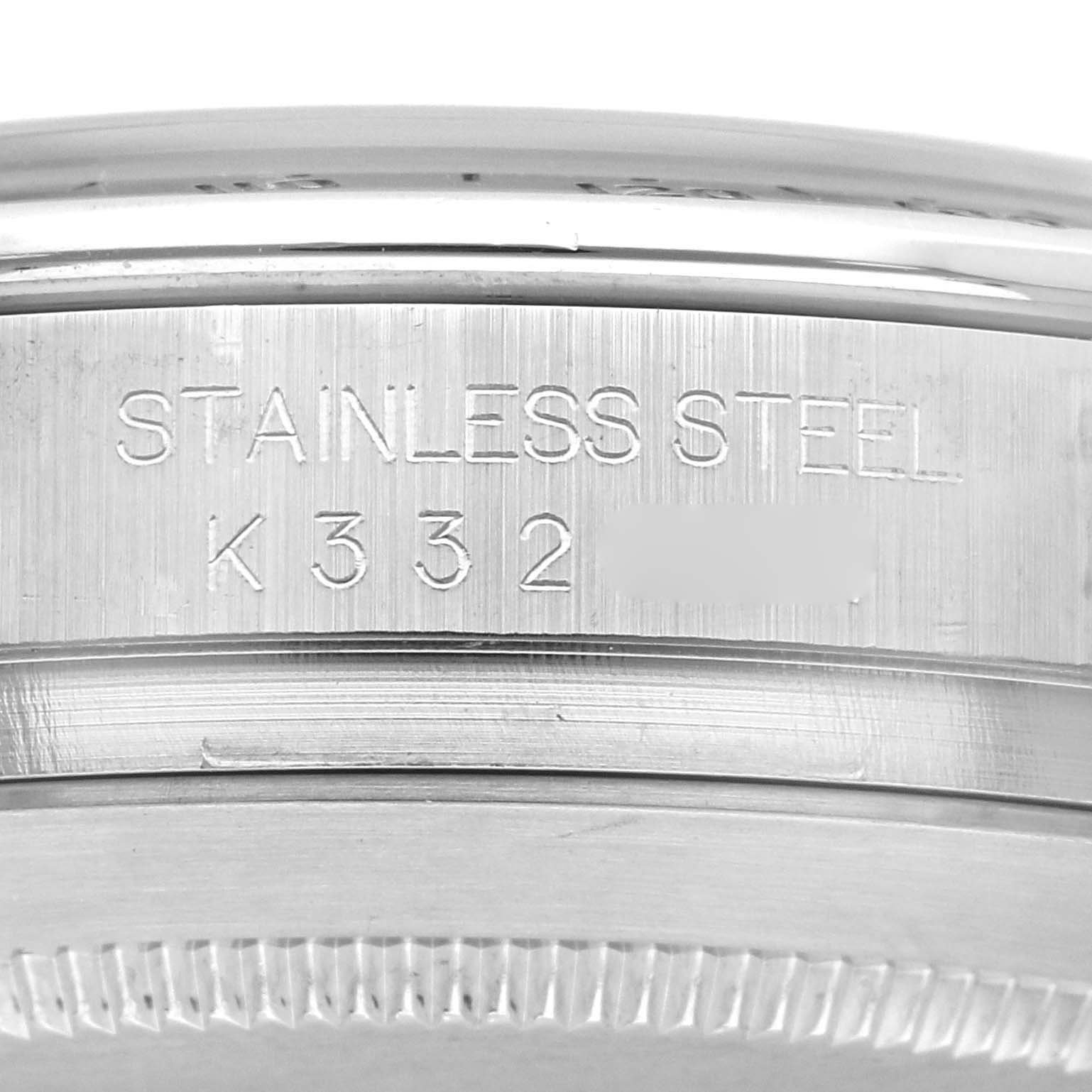 Close-up angle of the rim and side of a Rolex Daytona 116520 Men's Stainless Steel White Dial 116520 Men's Stainless Steel White Dial watch showing "STAINLESS STEEL" and a serial number engraved.