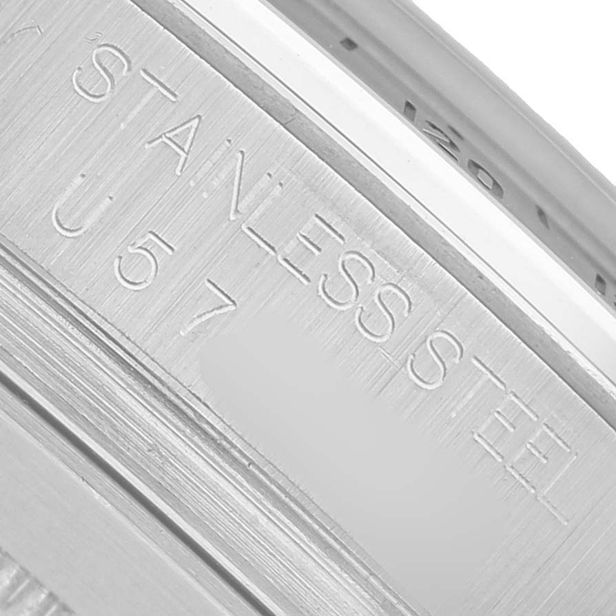 The image shows a close-up of the engravings on the stainless steel part of a Rolex Daytona 16520 Men's Stainless Steel Black Dial watch.