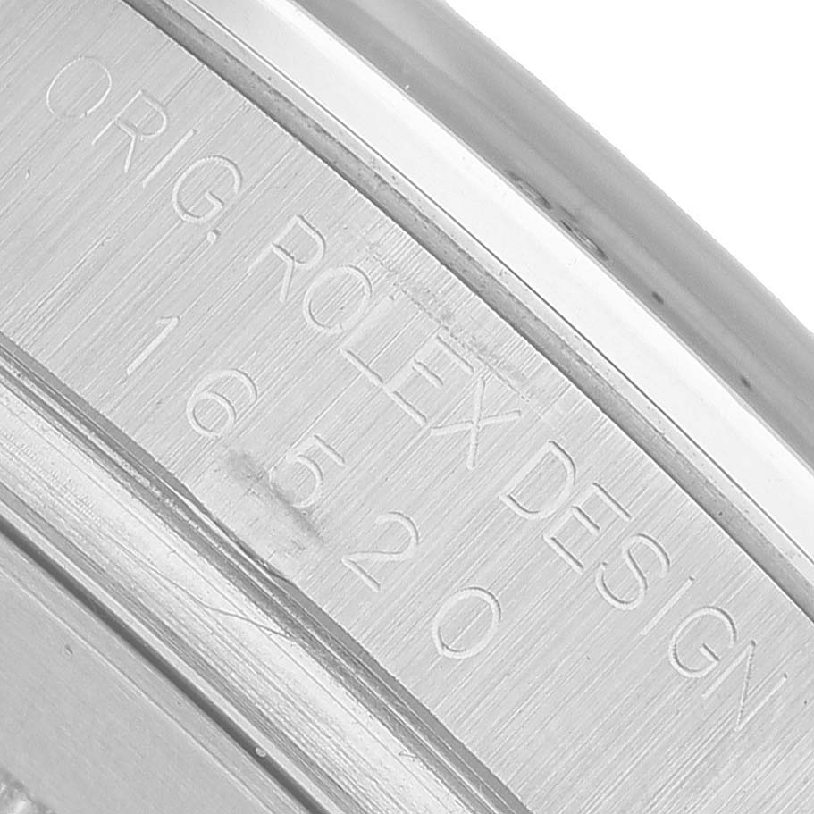 The image shows a close-up of the side engraving on the Rolex Daytona 16520 Men's Stainless Steel Black Dial, displaying "ORIG ROLEX DESIGN" and the model number.