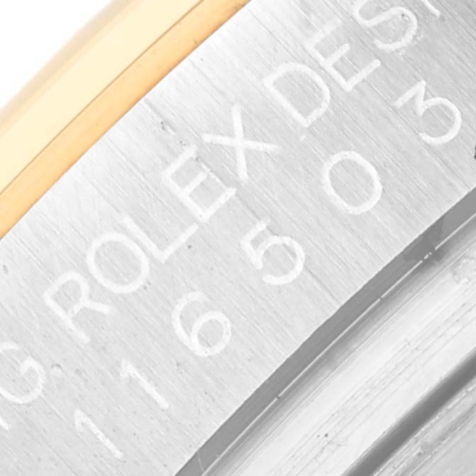 This image shows a close-up view of the engraved inner case and bezel area of a Rolex Daytona 116503 Men
s Steel and Gold (two tone) Black Dial 116503 Men
s Steel and Gold (two tone) Black Dial watch.