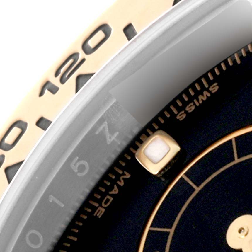 The close-up image shows the bezel and part of the dial of a Rolex Daytona 116503 Men
s Steel and Gold (two tone) Black Dial 116503 Men
s Steel and Gold (two tone) Black Dial watch.