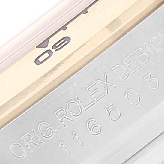 This image shows a close-up of the engraved side of the Rolex Daytona 116503 Men's Steel and Gold (two tone) Mother of Pearl Dial 116503 Men's Steel and Gold (two tone) Mother of Pearl Dial watch bezel and casing.