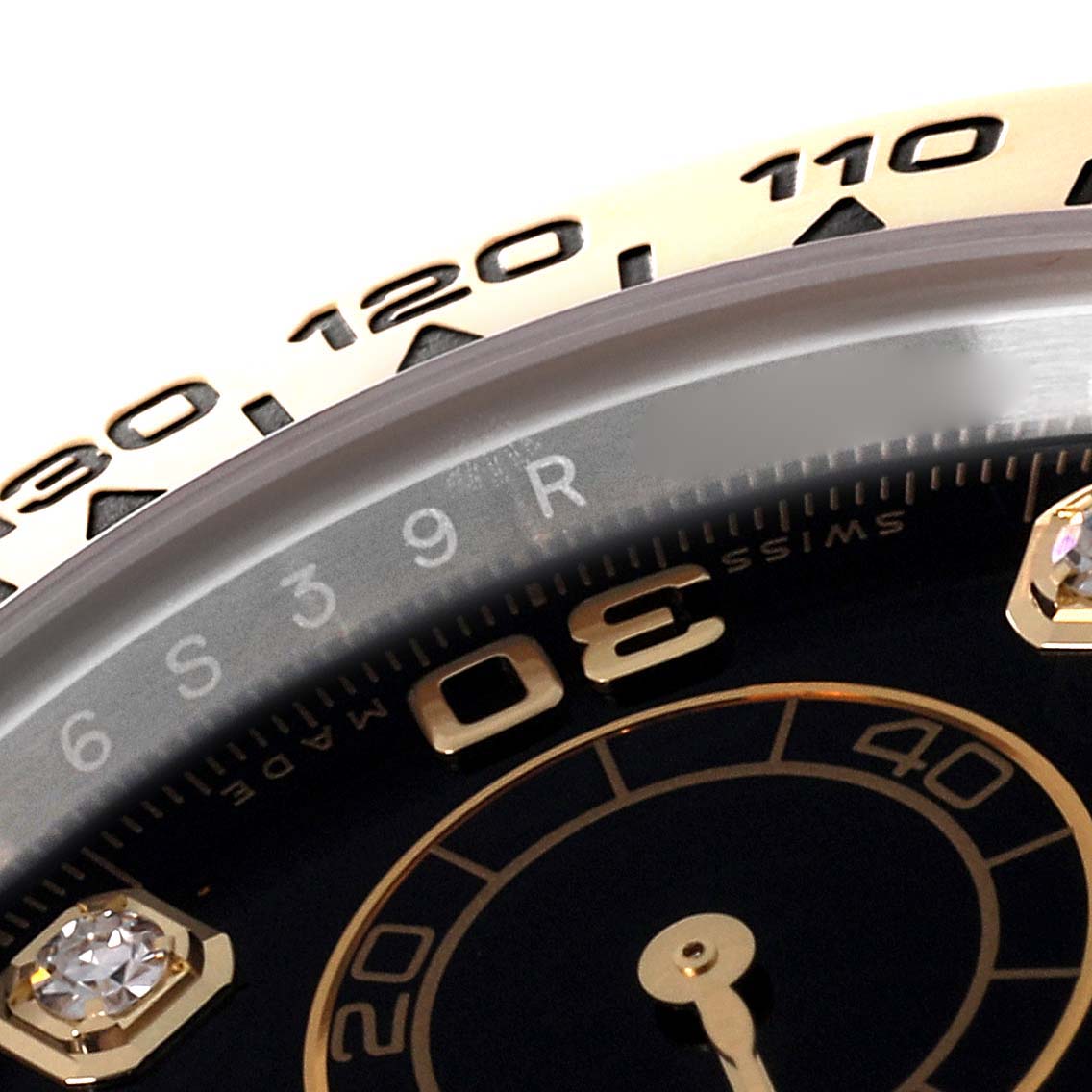 This close-up shows the bezel and part of the dial of the Rolex Daytona 116503 Men's Steel and Gold (two tone) Black Dial 116503 Men's Steel and Gold (two tone) Black Dial watch.