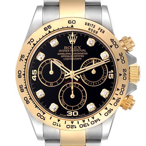 The image shows a front view of the Rolex Daytona watch, highlighting its black dial, gold bezel, and chronograph subdials.