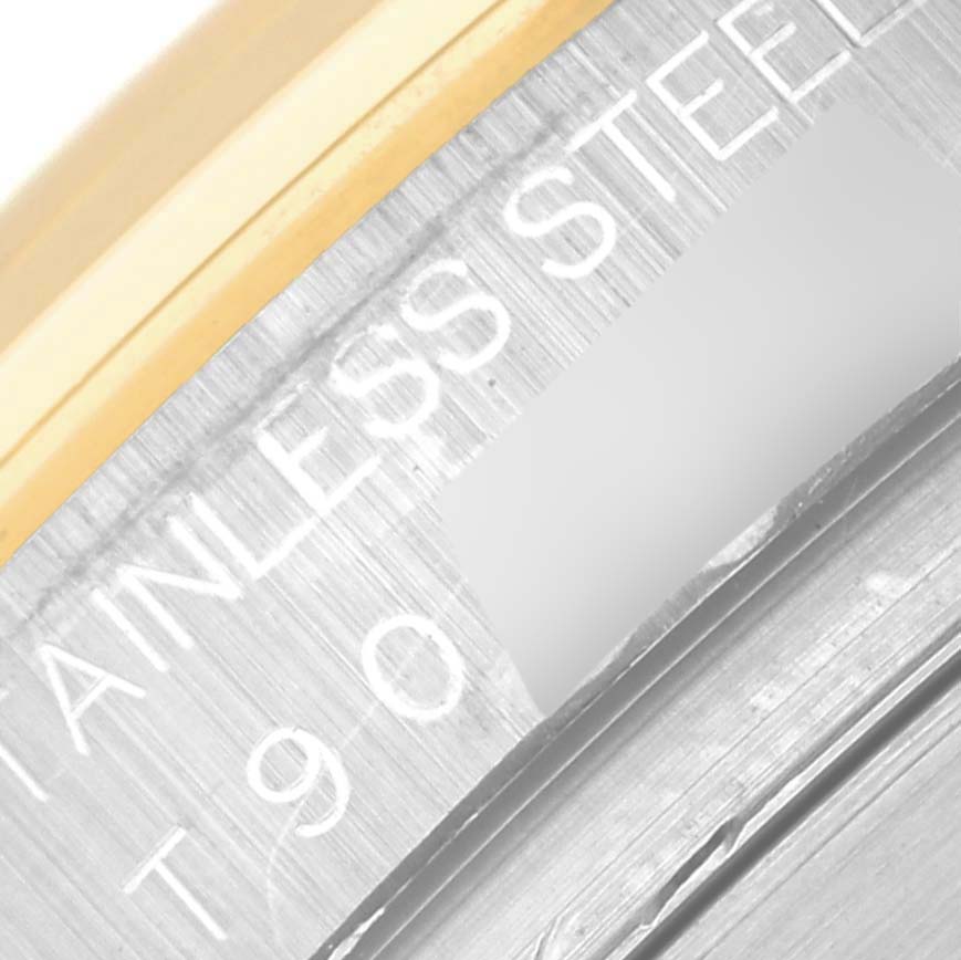 This close-up image shows the bezel and engraved text on the side of a Rolex Daytona 16523 Men's Steel and Gold (two tone) Champagne Dial 16523 Men's Steel and Gold (two tone) Champagne Dial watch.