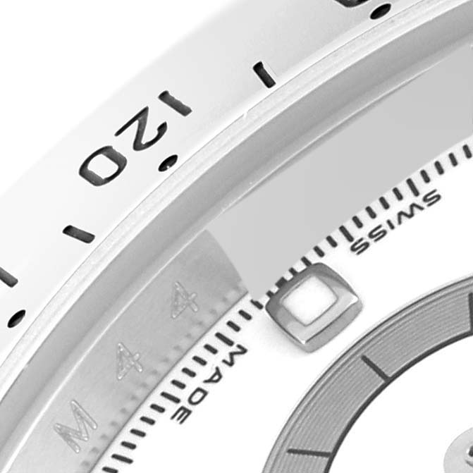 The image shows a close-up of the bezel, part of the dial, and markings of a Rolex Daytona 116520 Men's Stainless Steel White Dial 116520 Men's Stainless Steel White Dial watch.