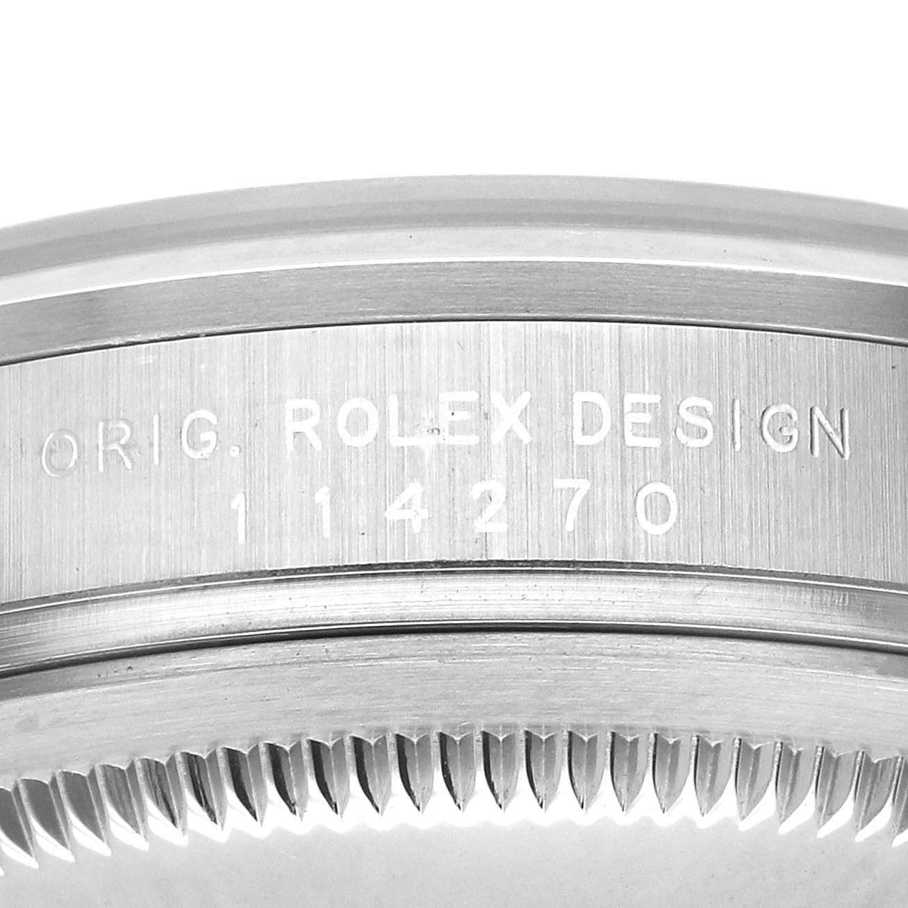 The image shows the side view of a Rolex Explorer 114270 Men's Stainless Steel Black Dial model, focusing on the engraved bezel and casing.