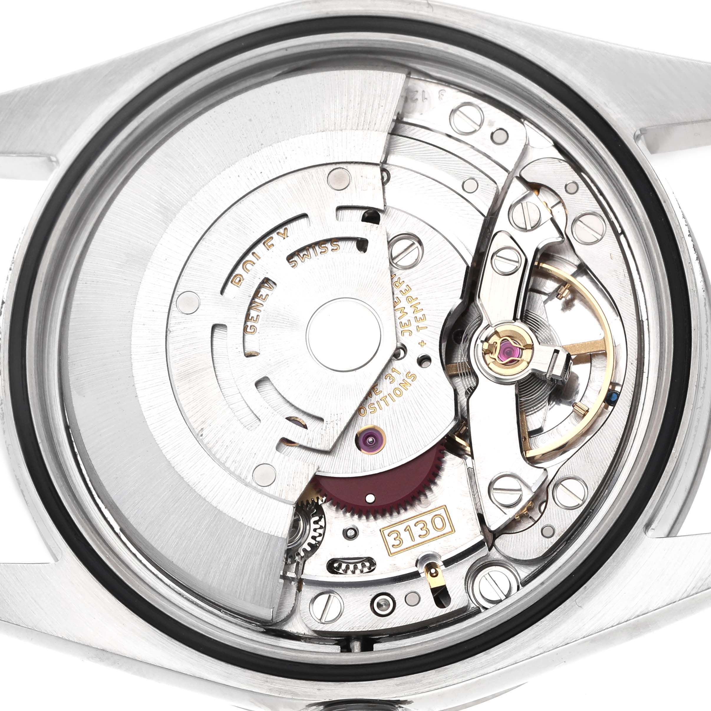 The image shows the movement of a Rolex Explorer 114270 Men's Stainless Steel Black Dial watch viewed from the back, highlighting mechanical components and engravings.