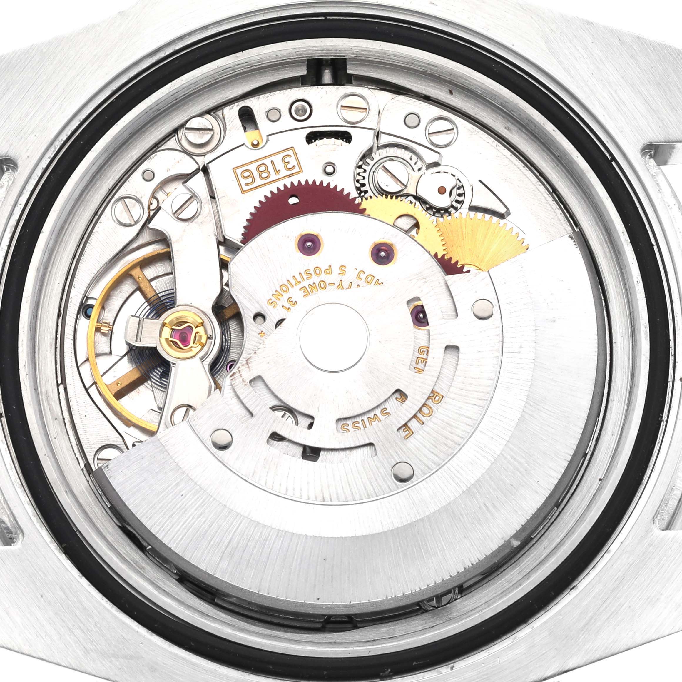 This image shows the internal mechanism and movement parts of a Rolex GMT-Master 116710 Men
s Stainless Steel Black Dial 116710 Men
s Stainless Steel Black Dial watch from a top-down angle.