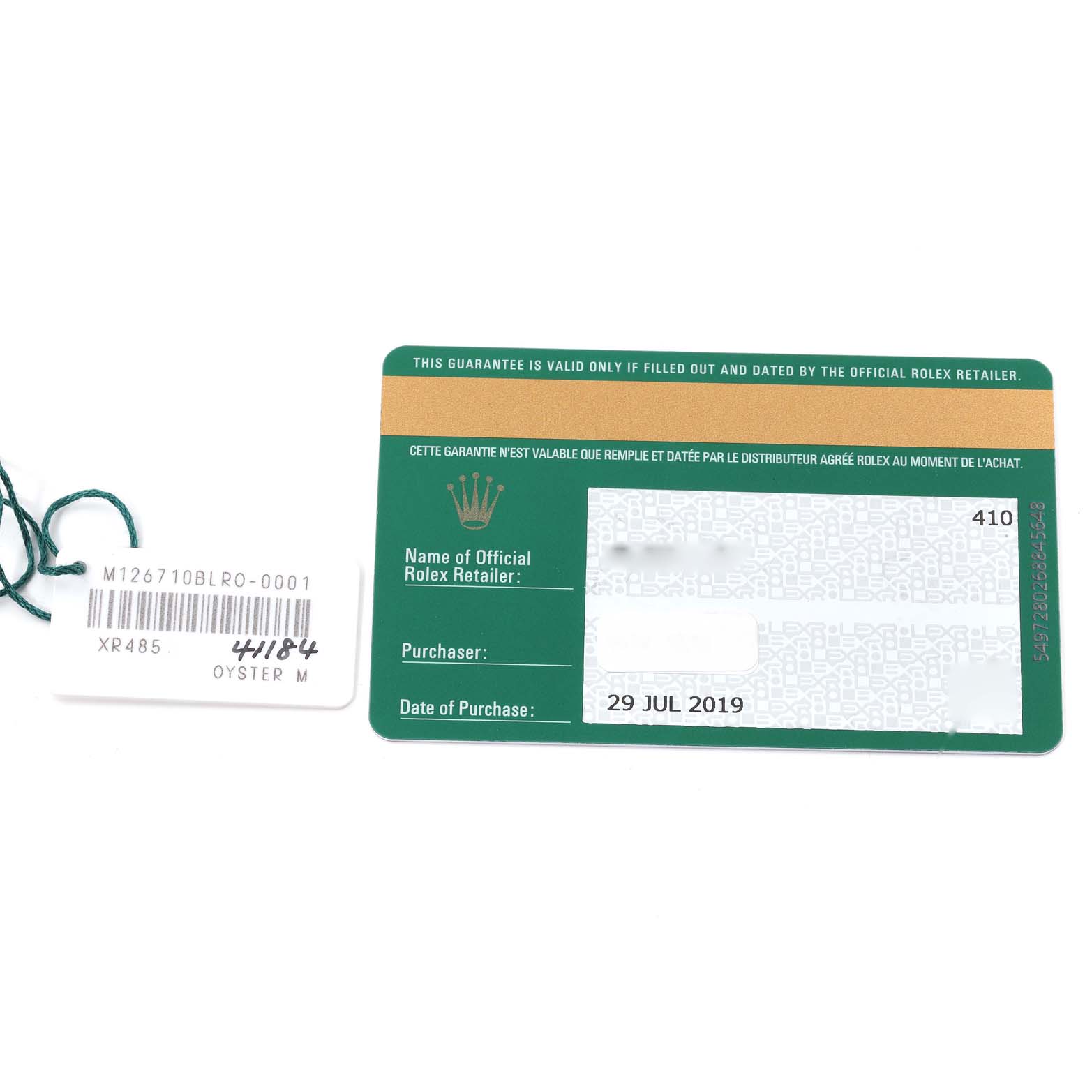 The image shows a Rolex GMT-Master 126710 Men's Stainless Steel Black Dial 126710 Men's Stainless Steel Black Dial warranty card and a tag with model details.