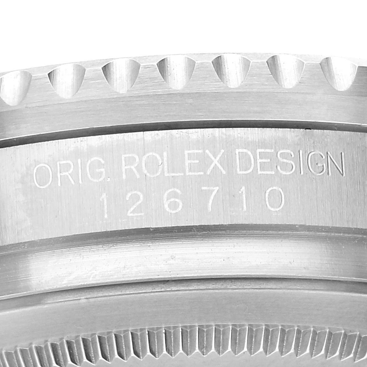 This image shows a close-up of the side of a Rolex GMT-Master 126710 Men's Stainless Steel Black Dial 126710 Men's Stainless Steel Black Dial, displaying "ORIG. ROLEX DESIGN" and the model number 126710.