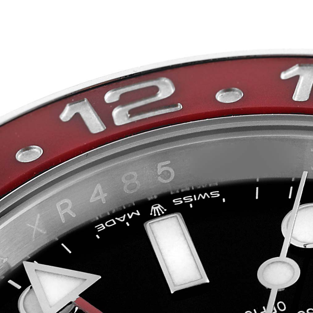 The image shows a close-up of the bezel and part of the dial of a Rolex GMT-Master 126710 Men's Stainless Steel Black Dial 126710 Men's Stainless Steel Black Dial watch.