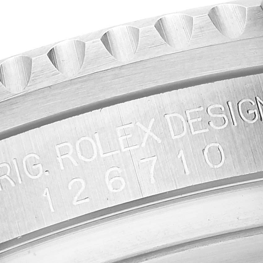 The image shows a close-up view of the engraved model number and part of the bezel of a Rolex GMT-Master 126710 Men's Stainless Steel Black Dial 126710 Men's Stainless Steel Black Dial watch.