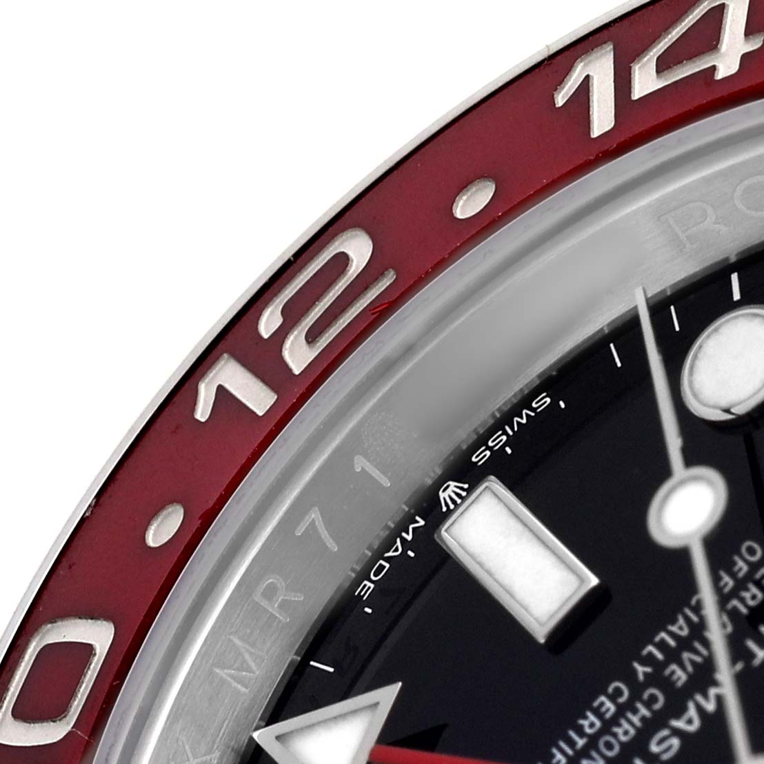 The image shows a close-up of the bezel and part of the dial of the Rolex GMT-Master 126710BLRO Men's Stainless Steel Black Dial, highlighting the red bezel and hour markers.