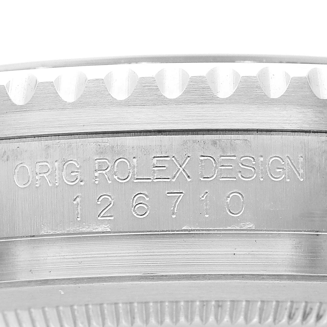 The image shows a close-up of the case side of a Rolex GMT-Master 126710BLRO Men's Stainless Steel Black Dial, focusing on the engraved model number and design.