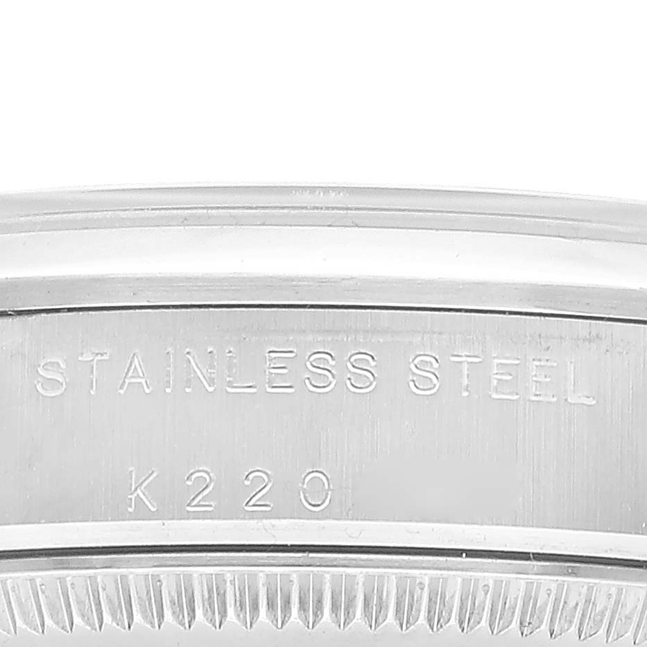 The image shows a close-up of the side of a stainless steel bezel from a Rolex Mid-Size 77080 Women's Stainless Steel Black Dial 77080 Women's Stainless Steel Black Dial watch.