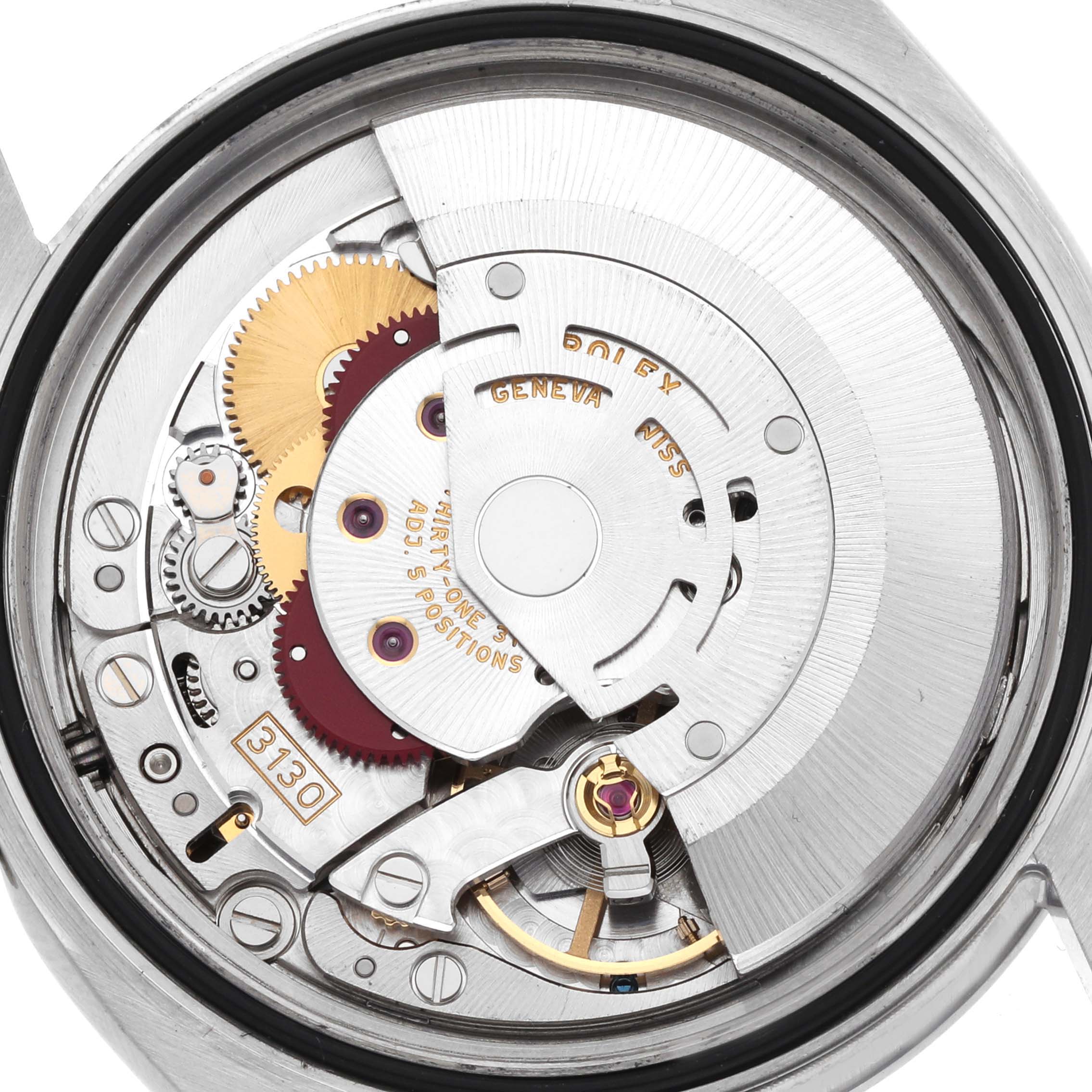 The image shows the inner mechanism of a Rolex Oyster Perpetual 116000 Men's Stainless Steel Black Dial, including gears and the rotor from a rear view angle.