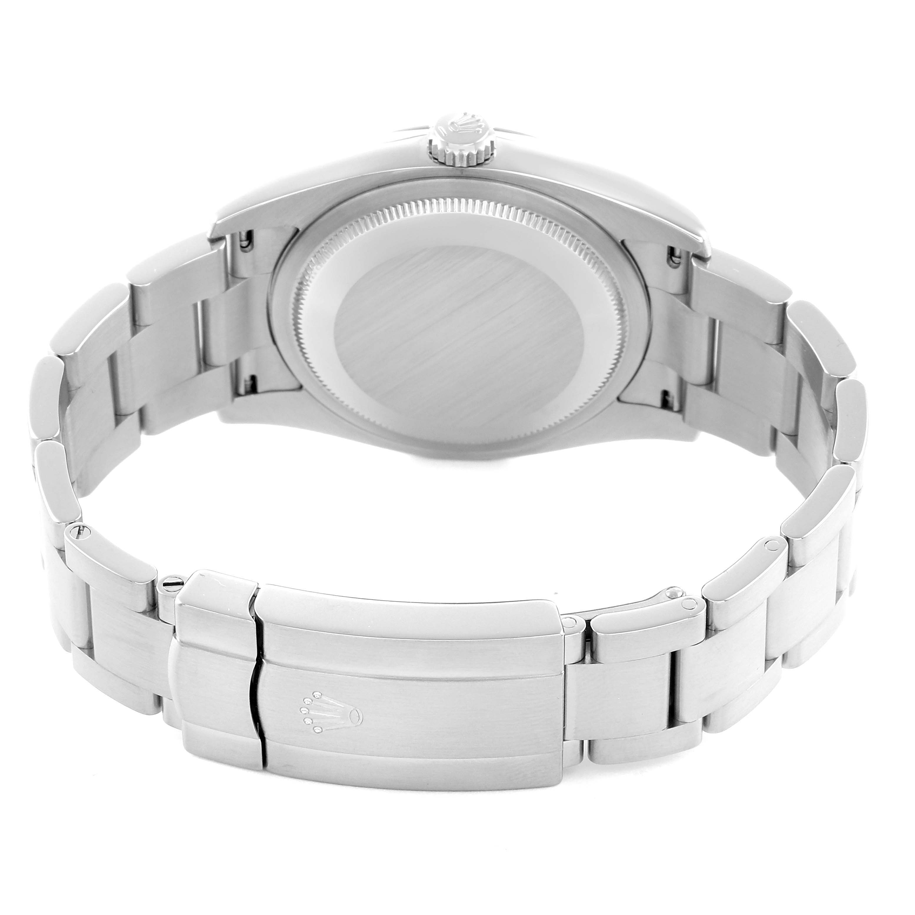 The image shows the back case and clasp of a Rolex Oyster Perpetual 116000 Men's Stainless Steel Black Dial watch from a rear angle.