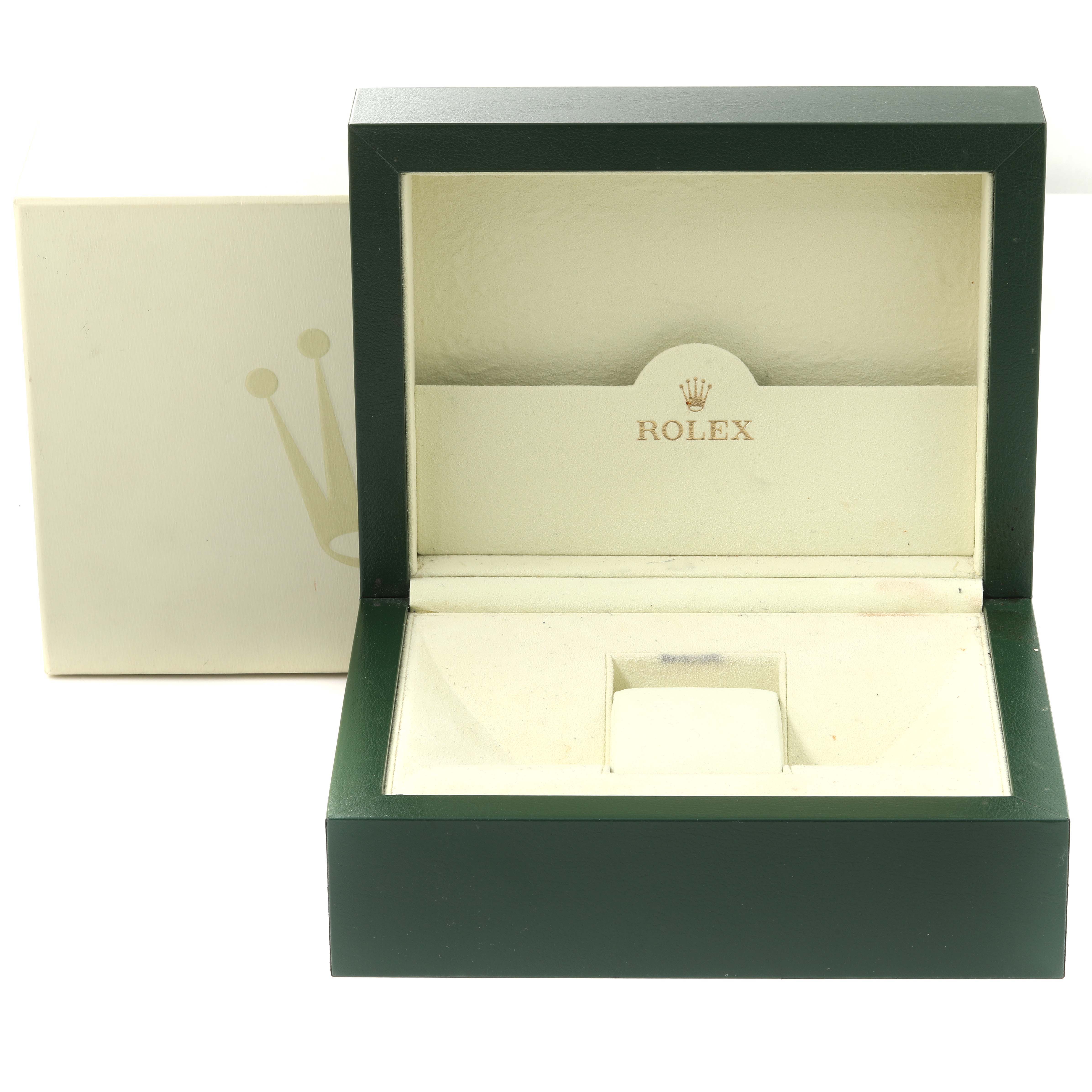 This image shows an open green and beige box for a Rolex Oyster Perpetual 114300 Men's Stainless Steel Grey Dial 114300 Men's Stainless Steel Grey Dial watch, viewed from the front.