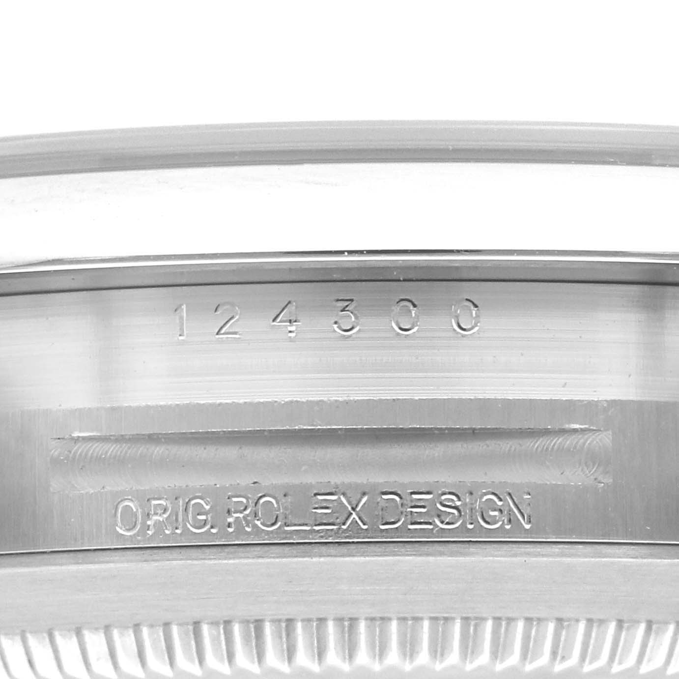The image shows a close-up of the case side of an Oyster Perpetual Rolex, featuring the model number "124300" and "OYSTER ROLEX DESIGN" engraving.