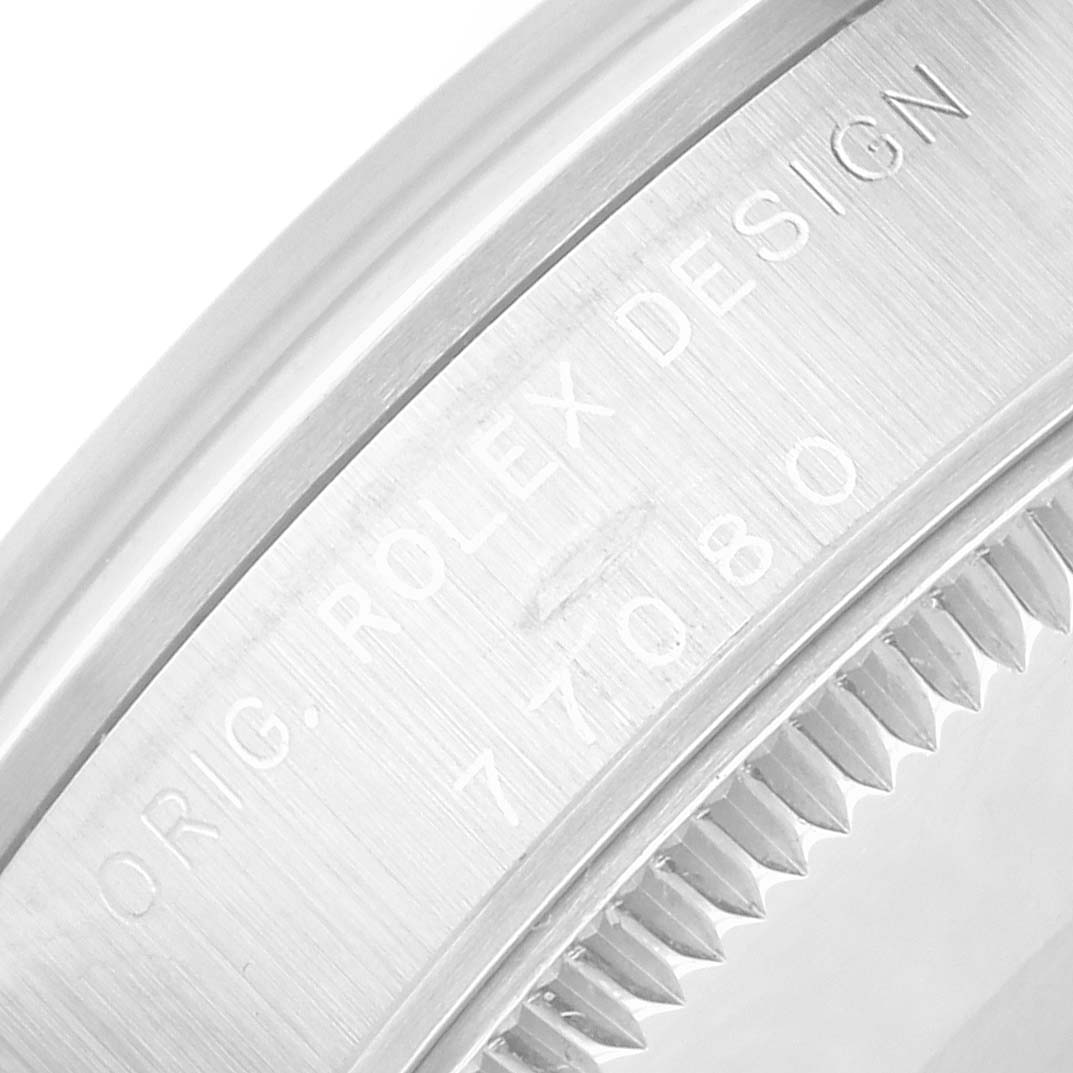 The image shows a close-up of the side engraving on a Rolex Oyster Perpetual 77080 Women's Stainless Steel Silver Dial watch case.