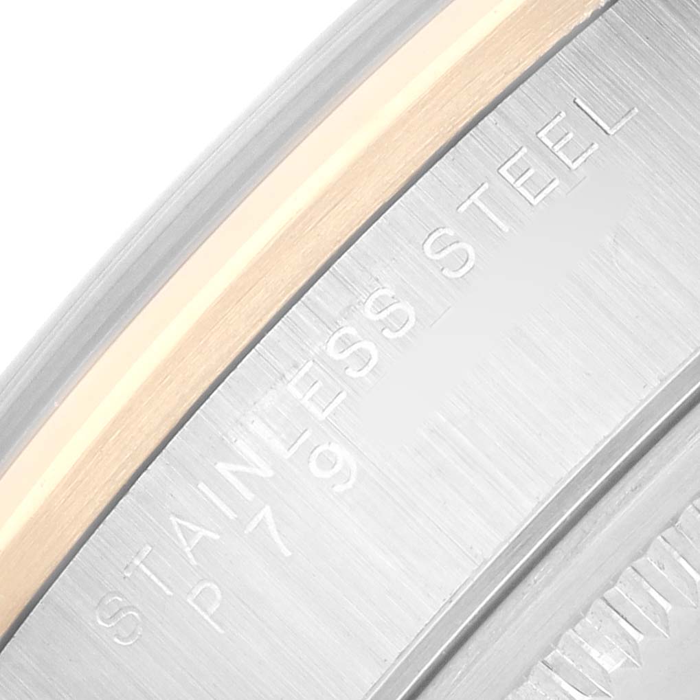 The image shows a close-up of the side of the bezel and case edge of a Rolex Oyster Perpetual 14203 Men's Steel and Gold (two tone) Silver Dial, highlighting the "Stainless Steel" engraving.